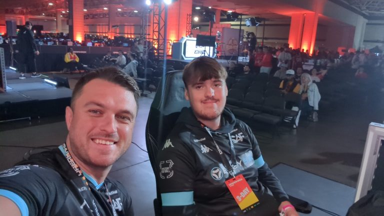 Two people in SAF shirts behind the scenes at an esports event